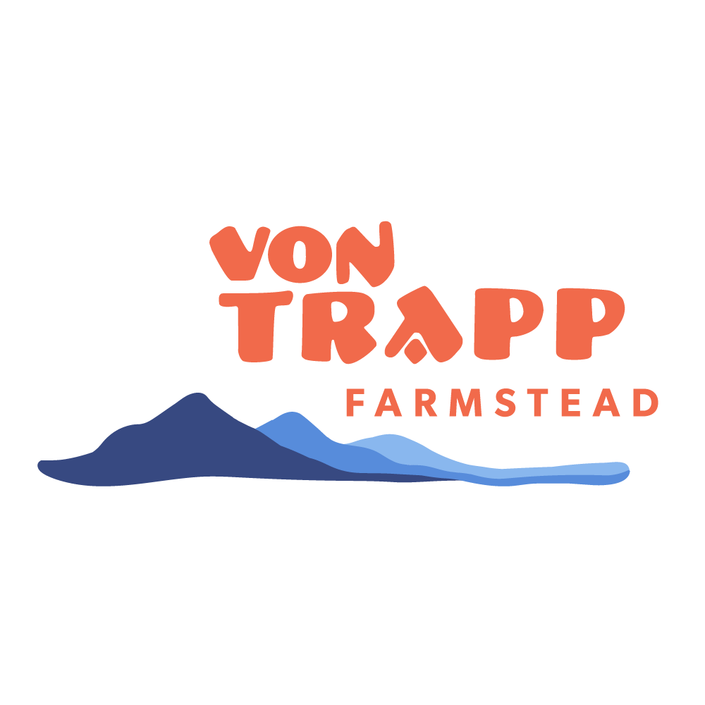 Logo of Von Trapp Farmstead featuring stylized mountains and colorful text.